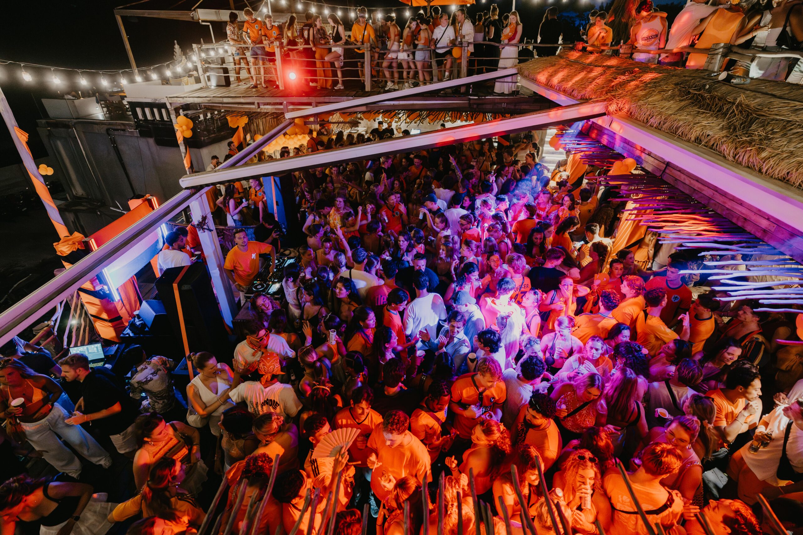 Kingsday rooftop party in Bali at Sol Rooftop Bali with crowd dancing and sunset atmosphere