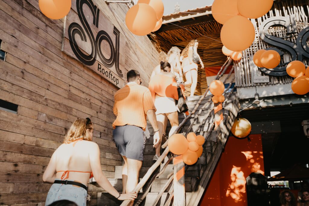 People climbing Sol Rooftop Bali stairs to enter the venue